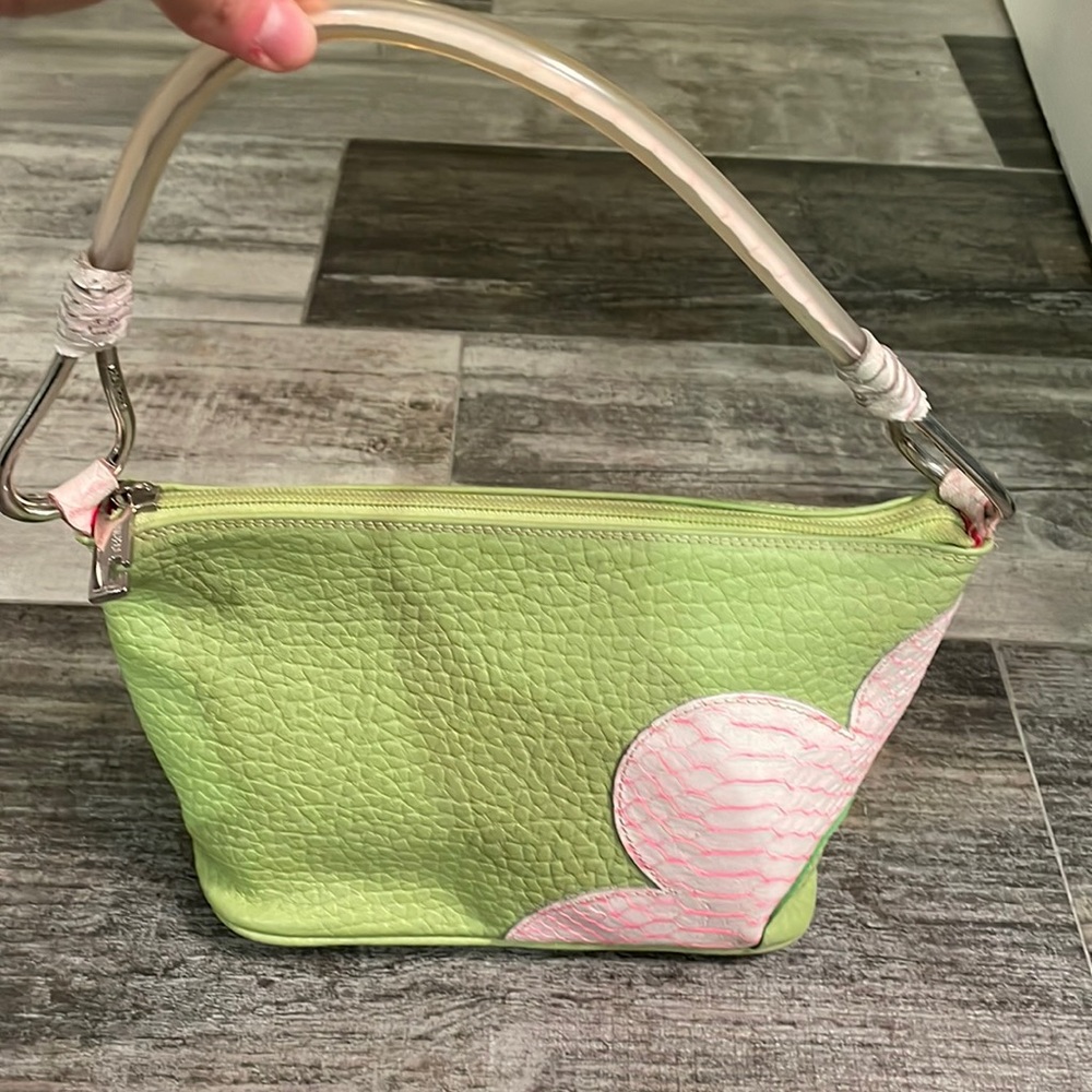 Green purse with pink flower.
